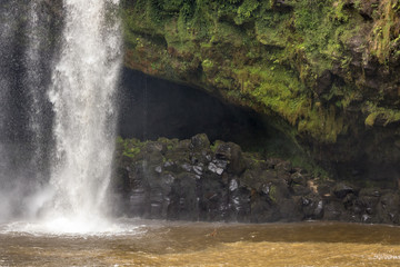 Fototapeta na wymiar Moss Covered Hidden Cave Behind Waterfall