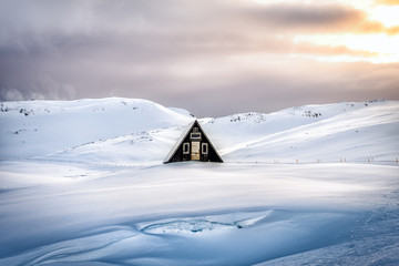 beautiful lonely cottage at snowy landscape