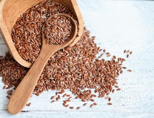  seeds of flax, sesame seeds, sunflower seeds on a wooden table. oil is rich in omega-3 fatty acids, diet.