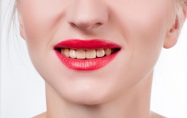 Fototapeta premium White teeth and red lips. Perfect female smile after whitening teeth.