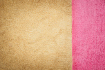 Top view of sandy beach with towel frame. Background with copy space and visible sand texture. Border composition made of towel