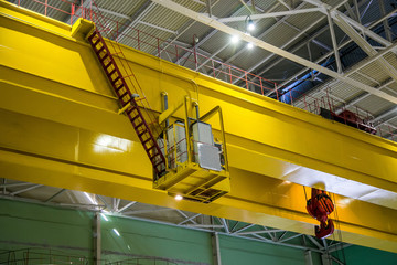 Industrial crane of bridge type inside factory or power plant 