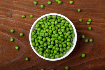 Green peas.In white bowl.On wooden background, table.Top view .Copy space