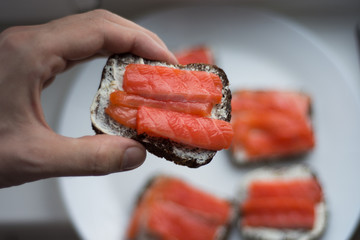 sandwich with fish on wooden background