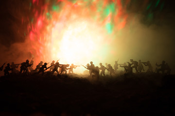 War Concept. Military silhouettes fighting scene on war fog sky background, World War Soldiers Silhouettes Below Cloudy Skyline At night. Attack scene. Armored vehicles. Tanks battle.