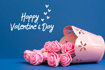 pink roses and paper hearts on blue background. text Happy Valentine's Day card 