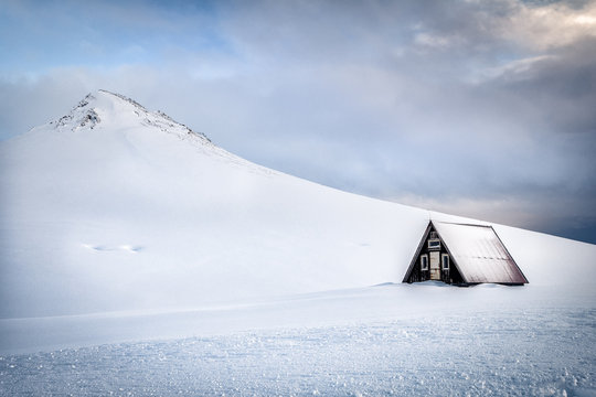 beautiful lonely cottage at snowy landscape