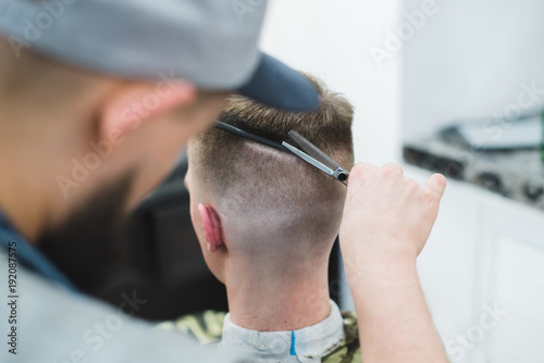 The Man Barber Creates A Stylish Hairstyle For The Client The