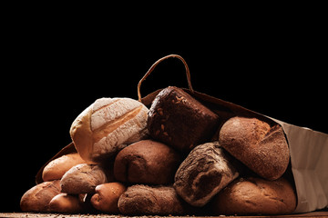 Fragrant bread on the table in a paper bag