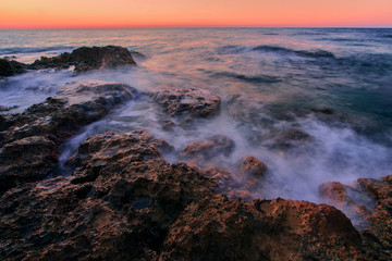 Fototapeta premium Beautiful cloudscape over the sea, fire sunrise shot. Rocks in Black Sea at sunset.