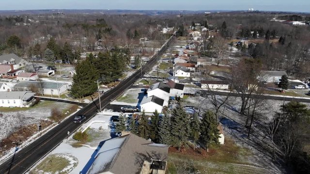 A fast flyover of typical Western Pennsylvania residential homes on a sunny winter day. Pittsburgh suburbs.  	