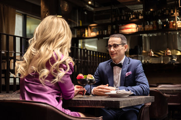 adult couple drinking cocktails at luxury restaurant
