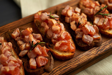 bruschetta with delicious fish on a cream cushion with capers and olive oil