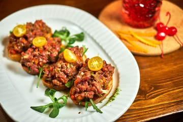 bruschetta, on slices of toasted baguette garnished with basil