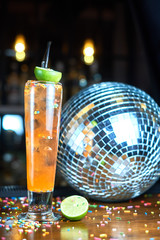 cocktail glass on the wood table in the bar. Slow motion