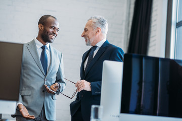 portrait of smiling multiracial businessmen in office