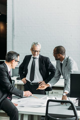 multiethnic businessmen discussing new business strategy on meeting in office