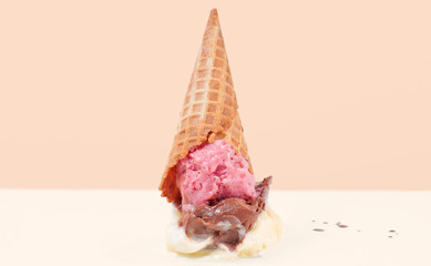 Ice cream on the ground.  Ice cream cone dropped on floor