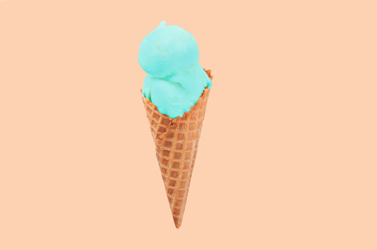 Pistachio ice cream cone on white background.