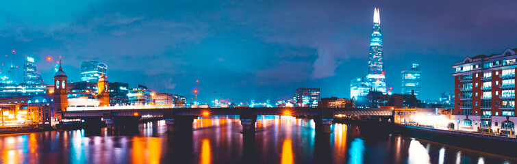 Fototapeta na wymiar Panorama of London Thames at night with Southwark Bridge, finance district and the shard