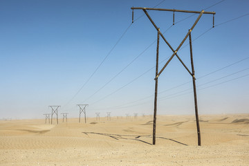 Electric poles passing through the desert