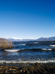 landscape of Lake Maggiore with strong wind and waves