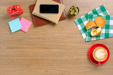 Wooden table with office supplies.