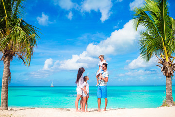 Family of four on the beach on caribbean vacation.
