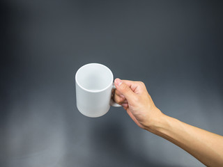 Empty mug with hand holding