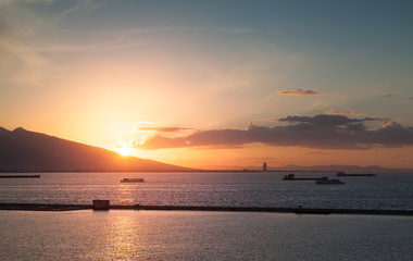 Dramatic colorful sunset landscape with ships