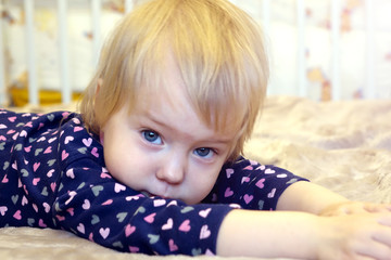 Fototapeta premium Beautiful child lying on the bed.