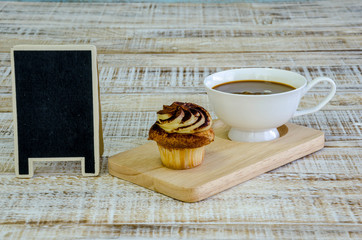 cupcake on wooden table on vintage background