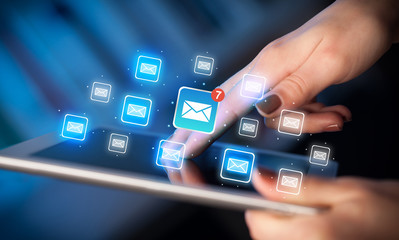 Fingers touching tablet with mail