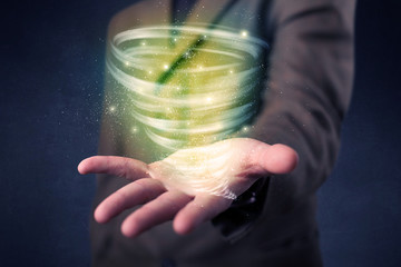 Businessman holding green tornado