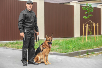 Security guard with dog, outdoors