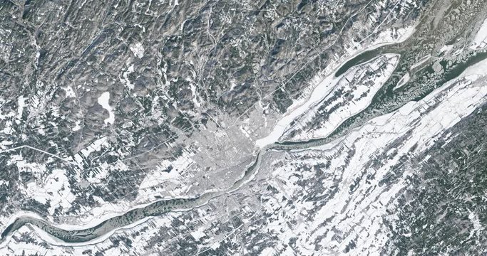 Very high-altitude overflight aerial of St. Lawrence River, Quebec City, Canada, in winter. Clip loops and is reversible. Elements of this image furnished by USGS/NASA Landsat