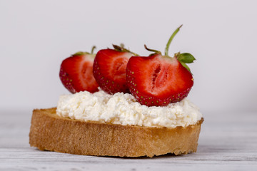 Sweet sandwiches with fresh red strawberry, cream cheese and honey