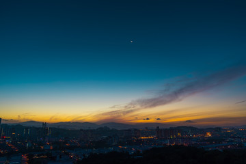 Beautiful natural sunrise  over silhouettes city skyline and amazing orange cloud blue sky above it .