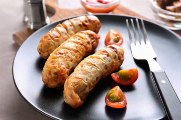 Plate with delicious grilled sausages, closeup