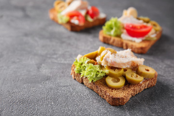Tasty chicken bruschettas on table