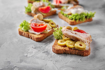 Tasty chicken bruschettas on table