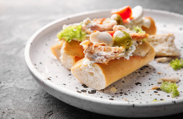 Plate with tasty chicken bruschettas on table