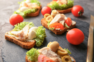 Slate plate with tasty chicken bruschettas, closeup