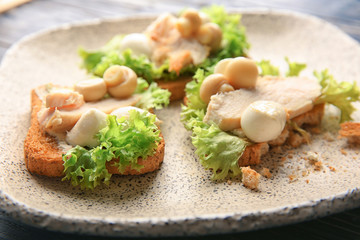 Plate with tasty chicken bruschettas, closeup
