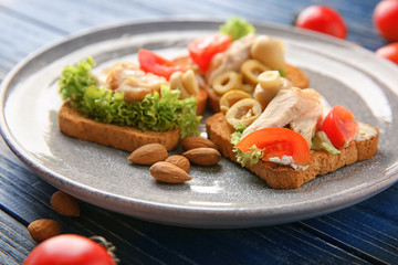 Plate with tasty chicken bruschettas, closeup