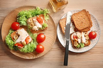 Tasty chicken bruschettas on wooden table