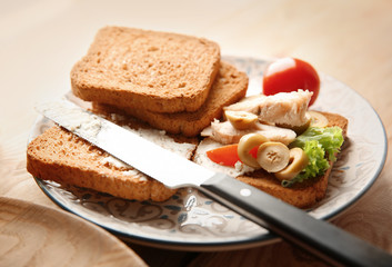 Plate with tasty chicken bruschetta and toasts, closeup
