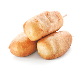 Tasty corn dogs on white background