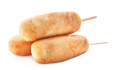 Tasty corn dogs on white background