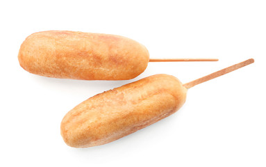 Tasty corn dogs on white background